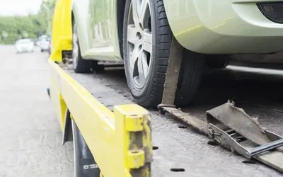 Wheel-lift tow truck securing an AWD vehicle in Cleveland